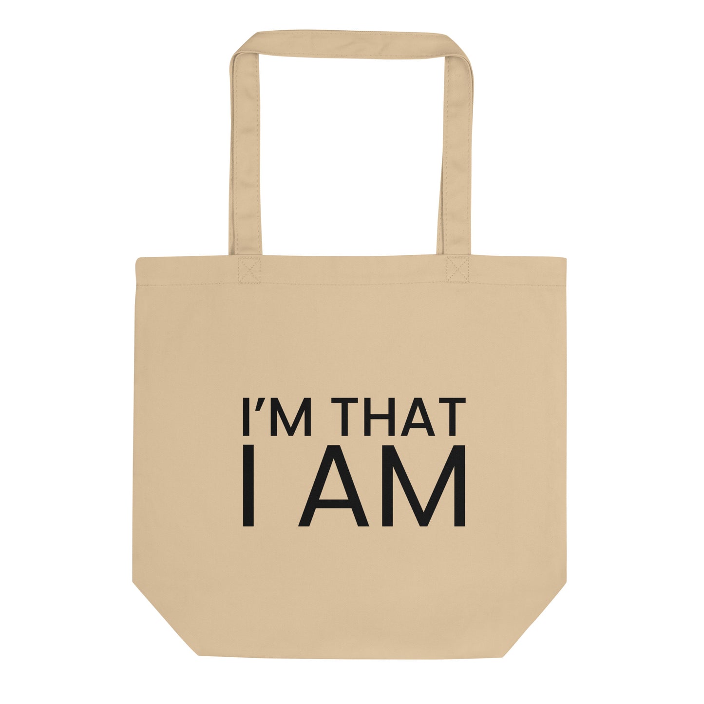 A light beige tote bag with the phrase "I'M THAT I AM" printed on the front in a bold, black, sans-serif font. The text is in all caps and is stacked on two lines. The phrase is a powerful declaration of self-existence and a profound affirmation of being.