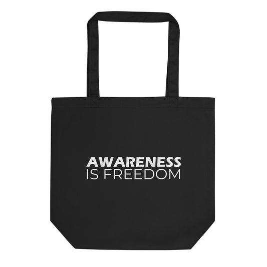 A black tote bag with the phrase "AWARENESS IS FREEDOM" printed on the front. The text is in a bold, white, sans-serif font, stacked on two lines, and is in all caps.