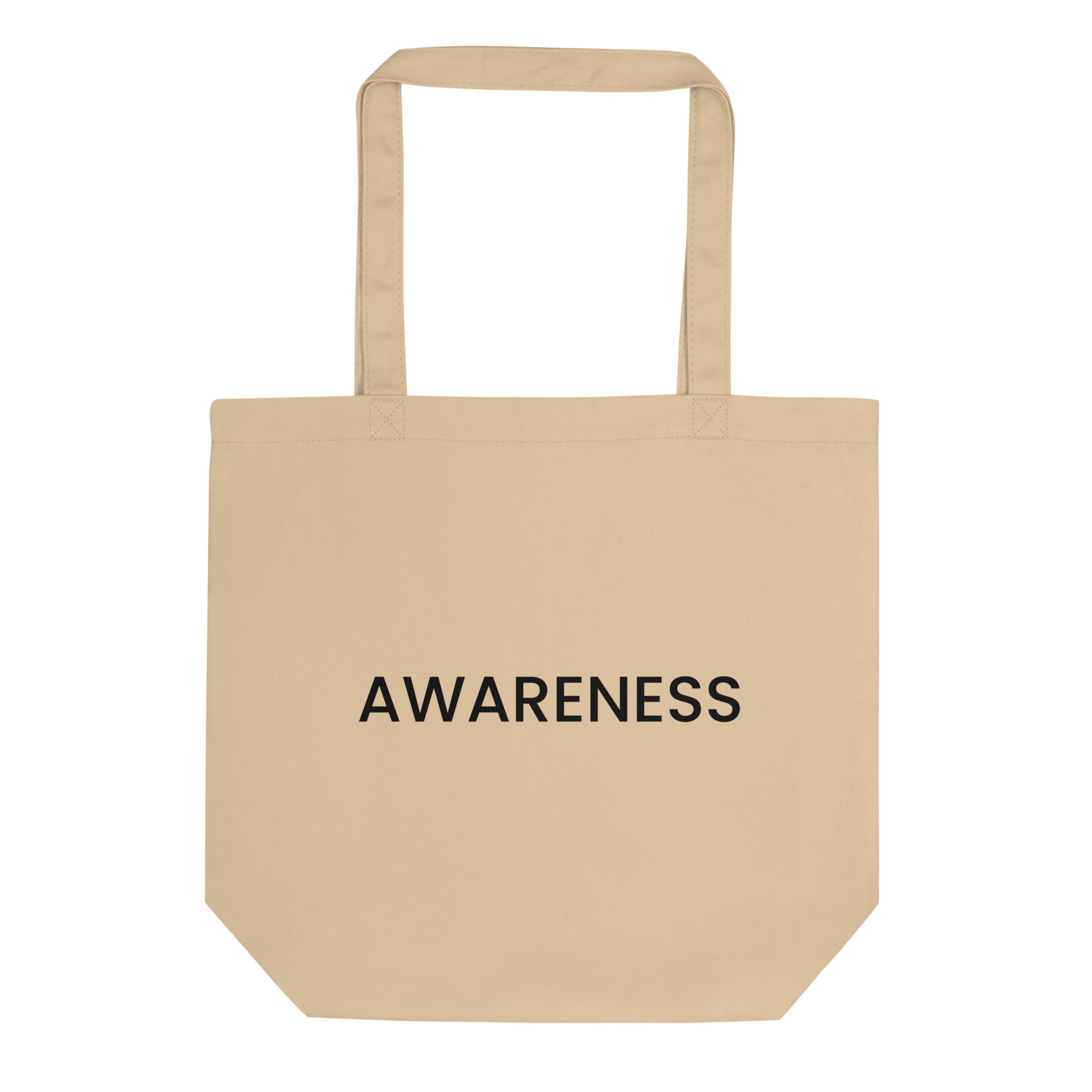 A light beige tote bag with the word "AWARENESS" printed on the front. The text is in a bold, black, sans-serif font, centered on one line, and is in all caps.