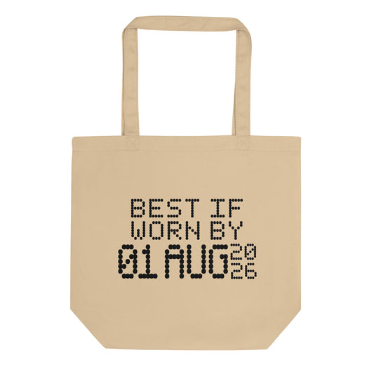 A minimalistic eco tote bag with the phrase “Best If Worn By 01 August 2026” printed in a bold, dot-matrix-style font. The design resembles an expiration date label, blending humor with clean, modern aesthetics.