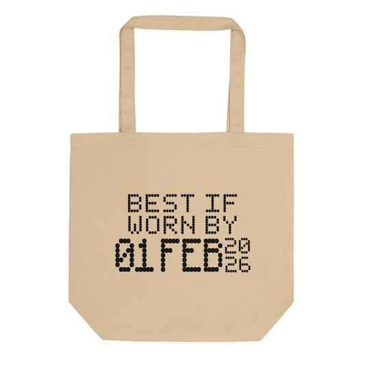A minimalistic eco tote bag with the phrase “Best If Worn By 01 February 2026” printed in a bold, dot-matrix-style font. The design resembles an expiration date label, blending humor with clean, modern aesthetics.