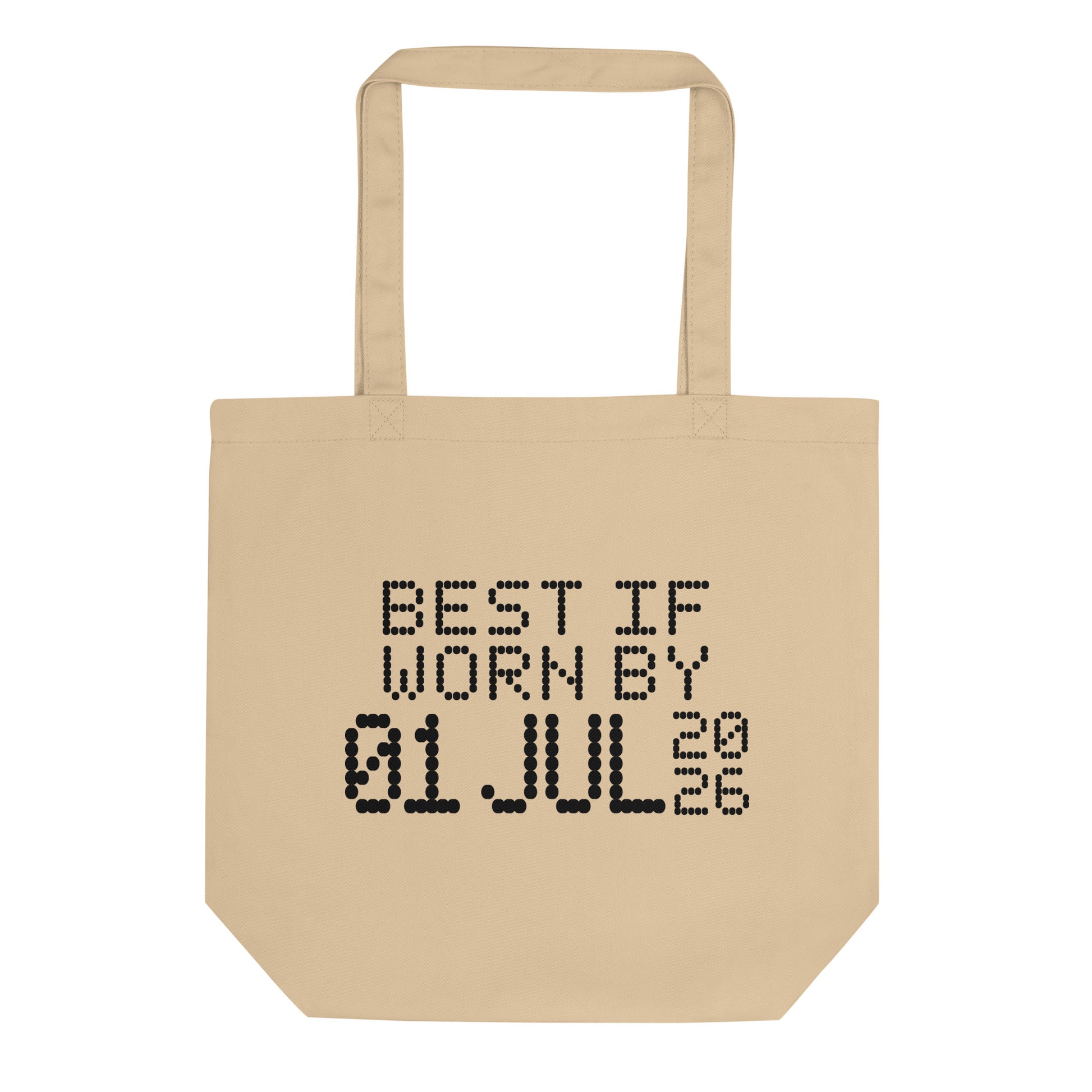 A minimalistic eco tote bag with the phrase “Best If Worn By 01 July 2026” printed in a bold, dot-matrix-style font. The design resembles an expiration date label, blending humor with clean, modern aesthetics.