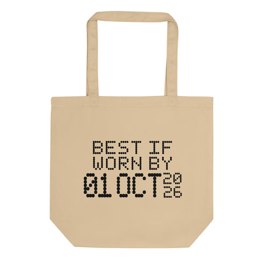 A minimalistic eco tote bag with the phrase “Best If Worn By 01 October 2026” printed in a bold, dot-matrix-style font. The design resembles an expiration date label, blending humor with clean, modern aesthetics.