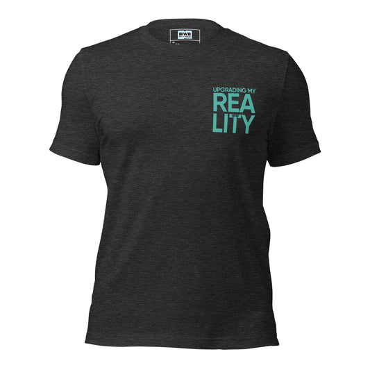 A bold, stacked layout reads “UPGRADING MY” in tight uppercase text, followed by the word “REALITY” split across two oversized lines — “REA” above “LITY.” A sleek pair of glasses rests on the crossbar of the “T,” turning typography into a quiet symbol of insight, transformation, and futuristic clarity.