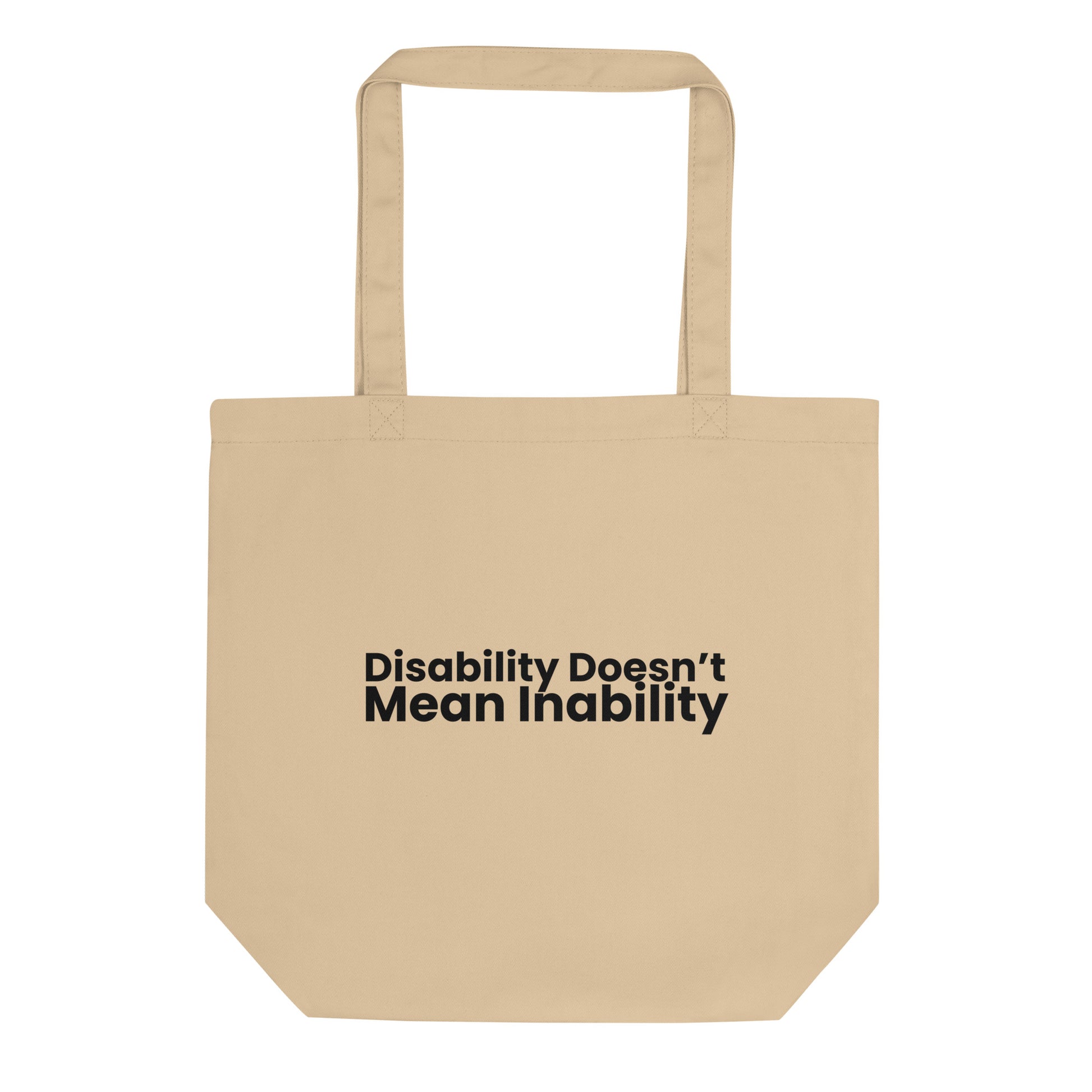 A light beige tote bag with the phrase "Disability Doesn't Mean Inability" printed on the front in a bold, black, sans-serif font. The text is stacked on two lines.