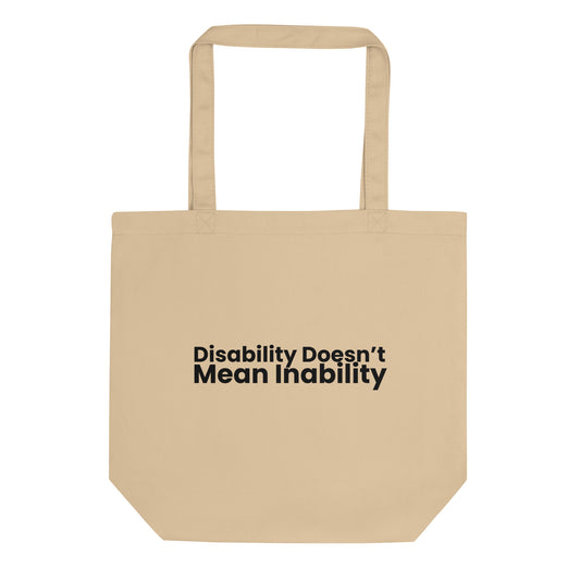 A light beige tote bag with the phrase "Disability Doesn't Mean Inability" printed on the front in a bold, black, sans-serif font. The text is stacked on two lines.