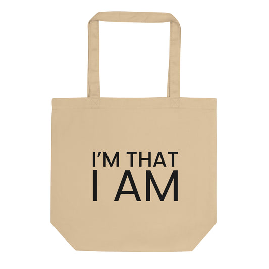 A light beige tote bag with the phrase "I'M THAT I AM" printed on the front in a bold, black, sans-serif font. The text is in all caps and is stacked on two lines. The phrase is a powerful declaration of self-existence and a profound affirmation of being.