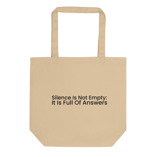A light beige tote bag with the phrase "Silence Is Not Empty: It Is Full Of Answers" printed on the front. The text is in a black sans-serif font and is stacked on two lines.