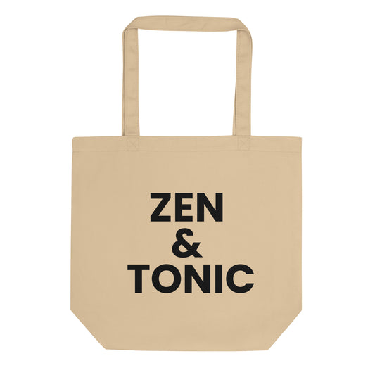 A light beige tote bag with the phrase "ZEN &amp; TONIC" printed on the front. The text is in a bold, black, sans-serif font and is stacked on three lines.
