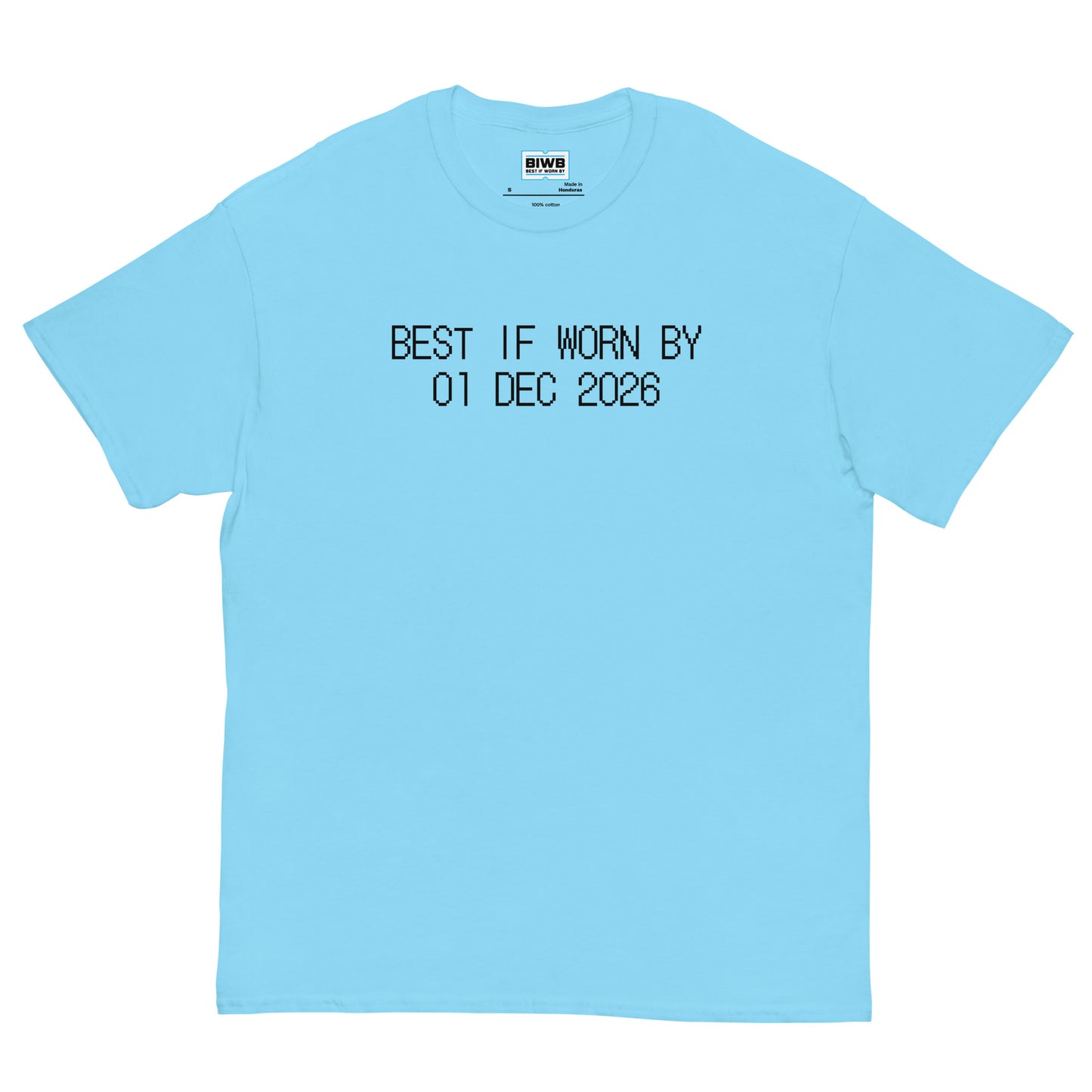 “BEST IF WORN BY 01 DEC 2026” appears in black dot matrix font, styled like a product expiration tag. The design is peaceful, clean, and thought-provoking.