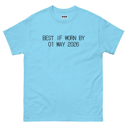 The phrase “BEST IF WORN BY 01 MAY 2026” in black dot matrix font mimics a best-before label, softly nudging the wearer to live consciously before time runs out.
