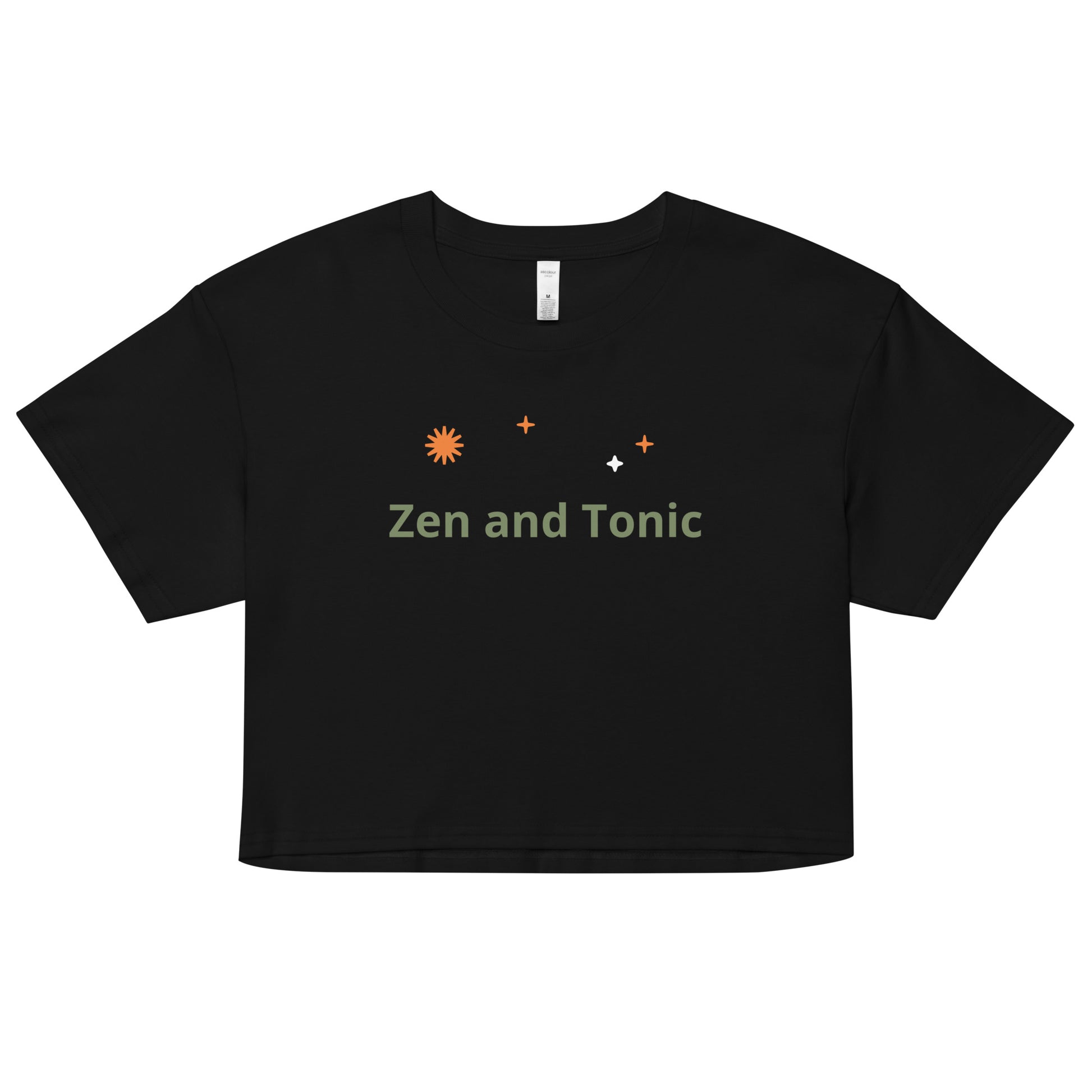 The phrase “Zen and Tonic” is in sage green font with orange starburst symbols above in random placement. This crop top is made of 100% combed cotton, which makes the shirt extremely soft and more durable than regular cotton shirts. The relaxed fit and dropped shoulders ensure comfortable wear, while the cropped length makes it perfect for spring and summer.