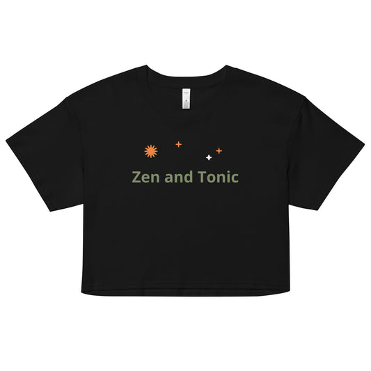 The phrase “Zen and Tonic” is in sage green font with orange starburst symbols above in random placement. This crop top is made of 100% combed cotton, which makes the shirt extremely soft and more durable than regular cotton shirts. The relaxed fit and dropped shoulders ensure comfortable wear, while the cropped length makes it perfect for spring and summer.